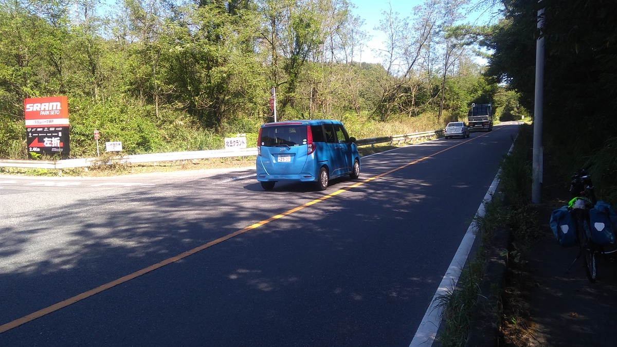 A small blue van following the sedan and truck from the previous photograph.