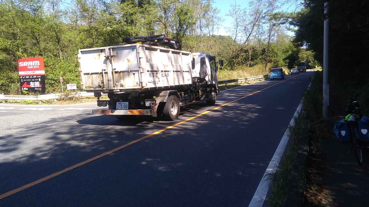 A large truck with a steel box for hauling construction rubbish, following the van, sedan, and truck from the previous photographs.